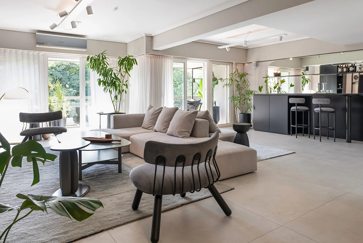 Residential living room at Arenales Apartment with bar and balcony view.