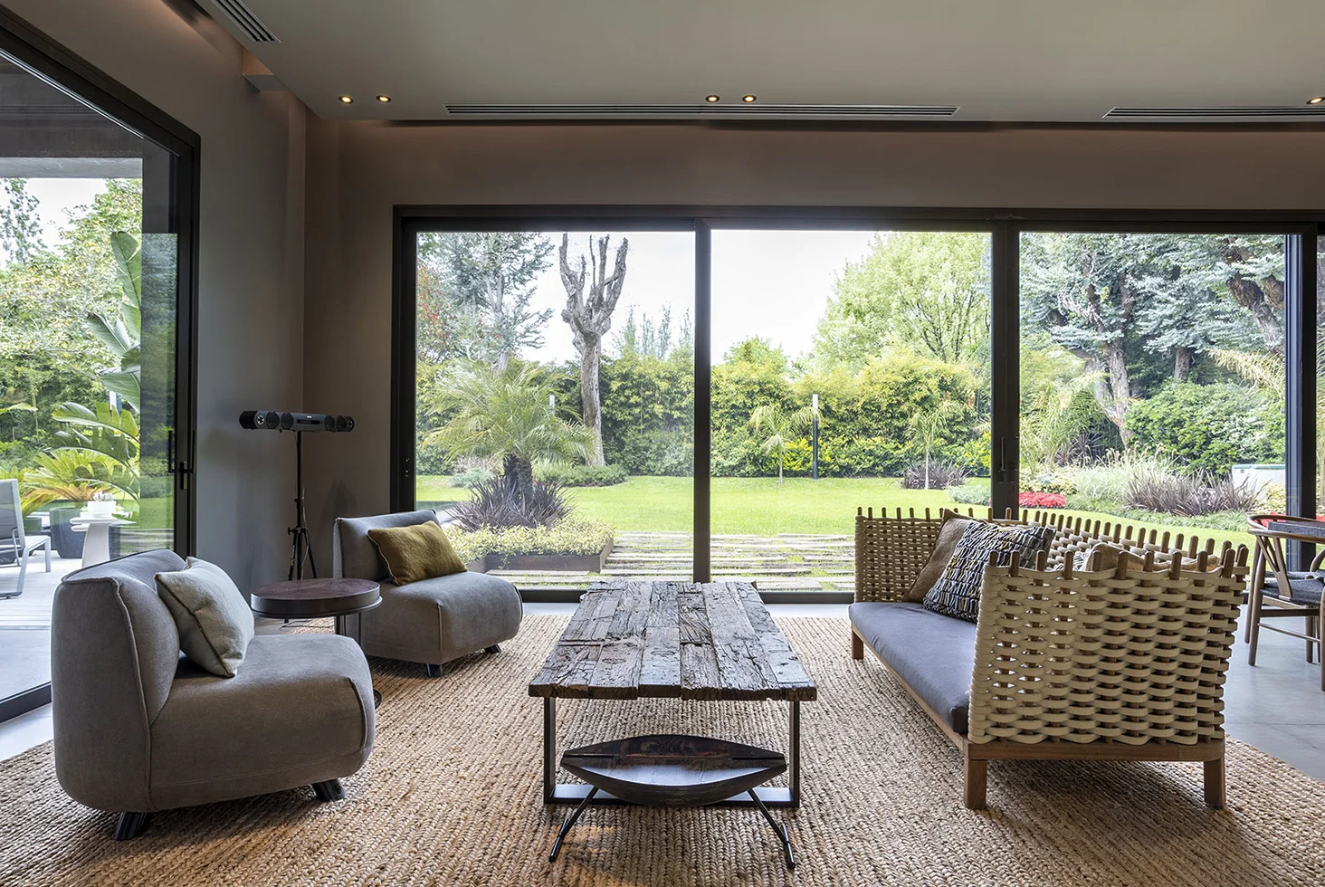 Highland Park residential living room with garden view and rustic table.