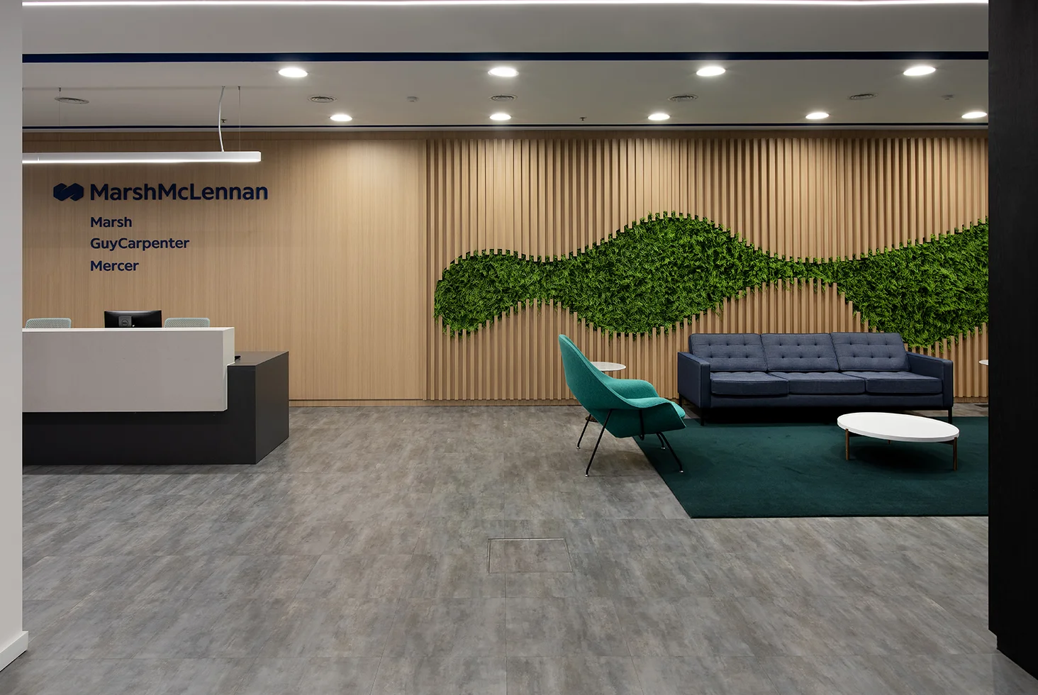 Reception area with green wall and seating.